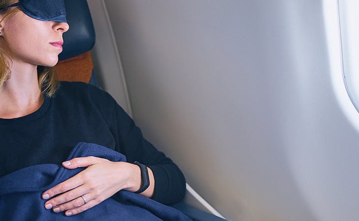 image of woman sleeping on airplane