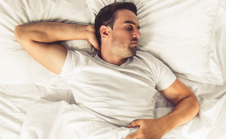 person sleeping on back on latex mattress