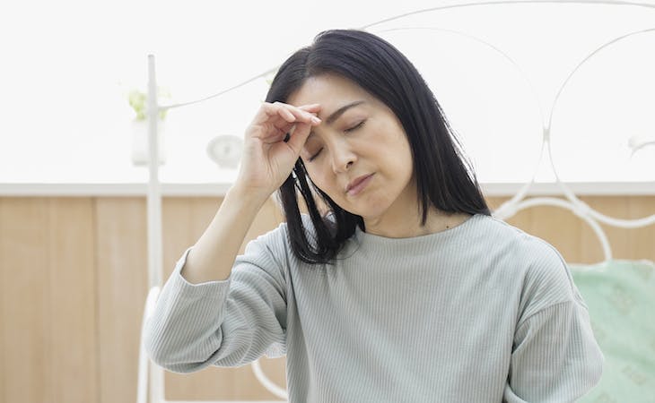 menopause and sleep - middle-aged person with headache