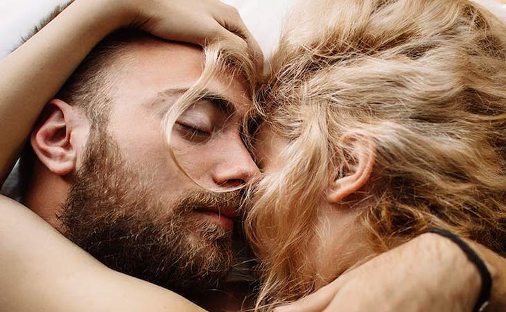 image of couple sleeping together in bed