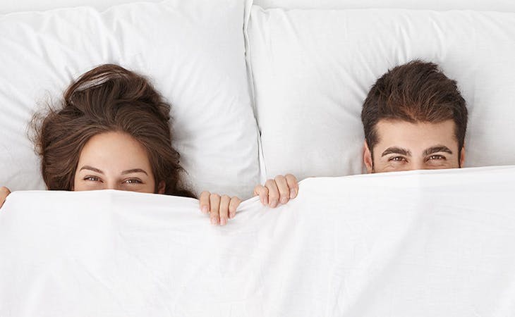 sleep habits of couples survey results - image of couple in bed