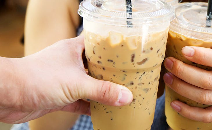 image of teens holding iced coffee