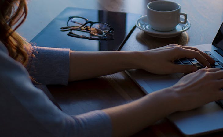 early bird vs night owl - image of woman at computer at night