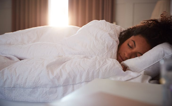 sleep stages - image of person sleeping in bed