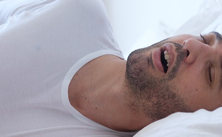 image of man snoring in bed