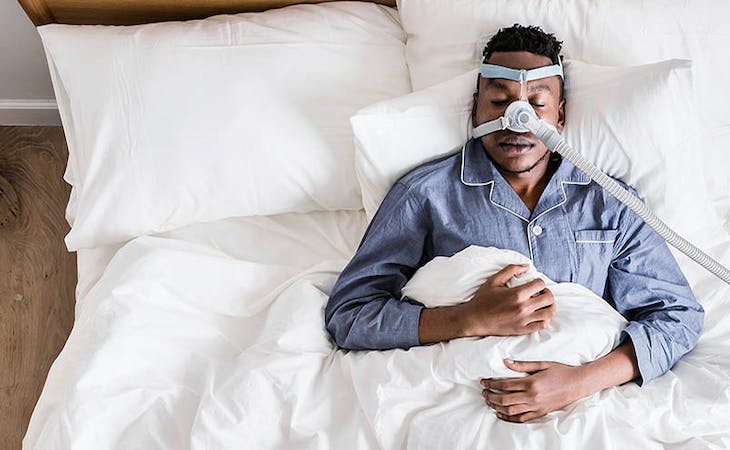 image of man with sleep apnea wearing CPAP machine