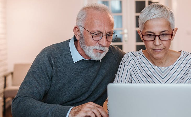 image of couple reading mattress customer reviews online