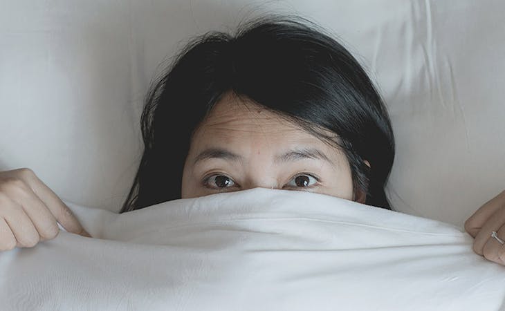 image of woman lying in bed