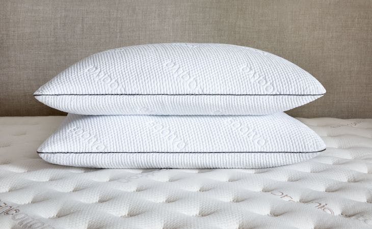 saatva memory foam pillows stacked on bed