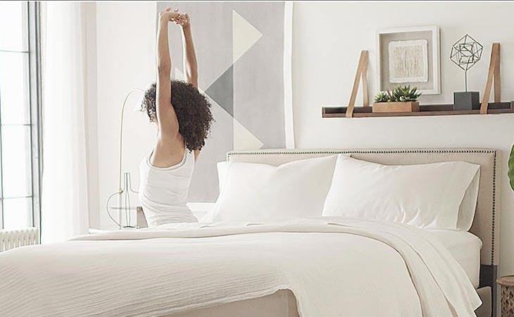 image of person stretching on innerspring mattress