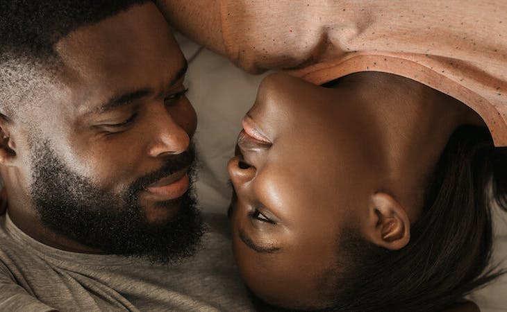 image of couple sleeping in bed with one person snoring