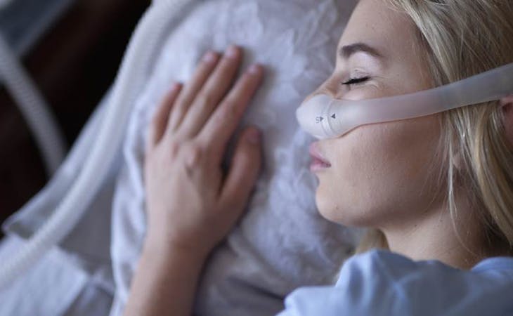 image of person wearing cpap machine for sleep apnea