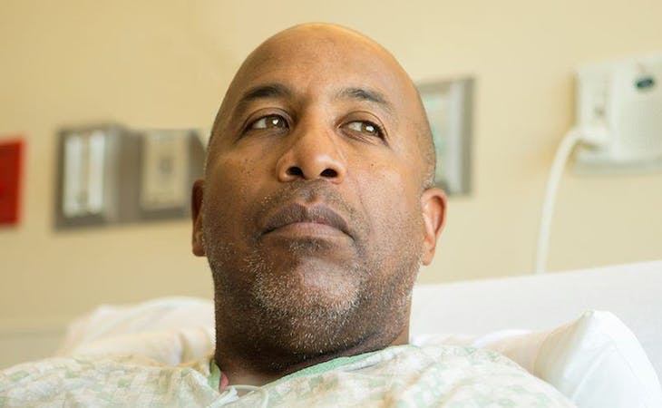 image of person with cancer in hospital bed