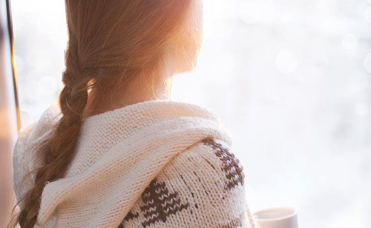 image of woman with seasonal affective disorder looking out window