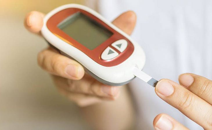 image of person with diabetes checking blood sugar