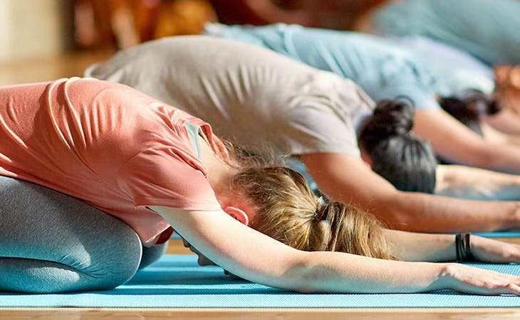 image of people in yoga class doing child's pose