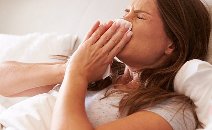 image of person with allergies sneezing