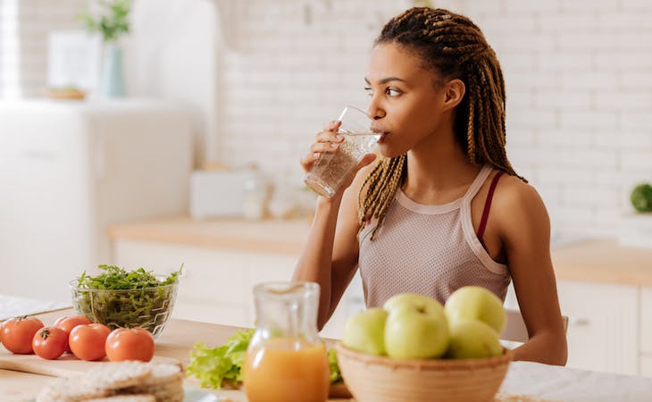 person drinking water as part of morning routine
