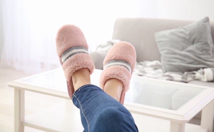 image of person's feet in slippers at home