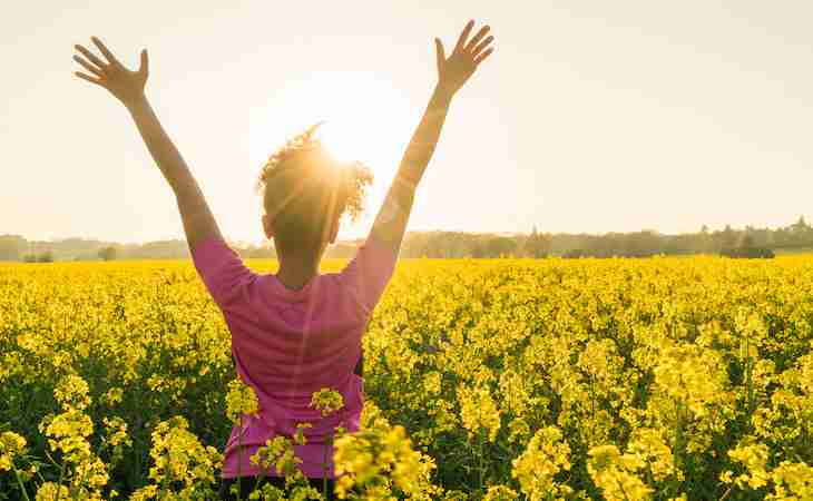 person outside in a field of flowers