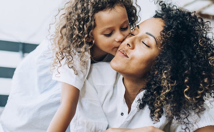 image of mom and child cuddling on bed