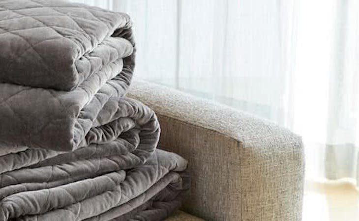 saatva organic weighted blanket folded on couch