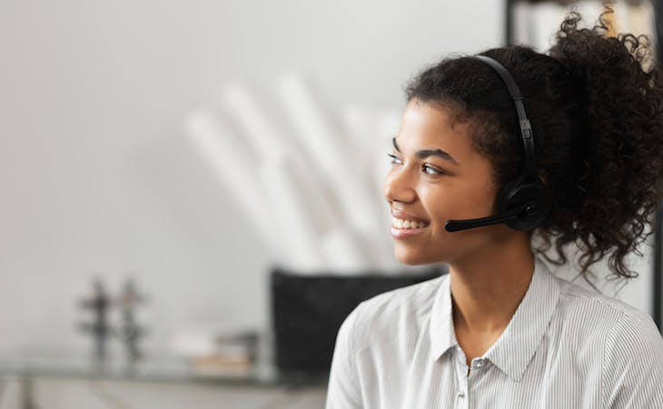 customer service representative with headset on smiling