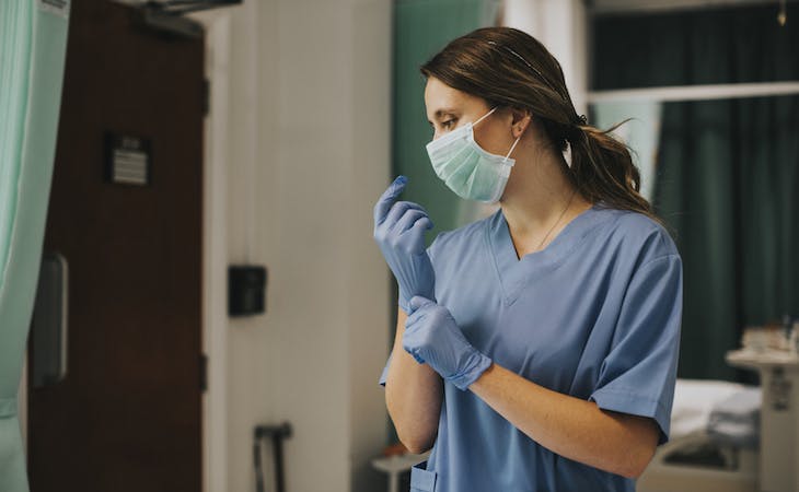 nurse in hospital wearing a face mask and gloves