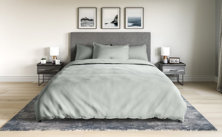 bed with a saatva duvet cover and pillow shams on it