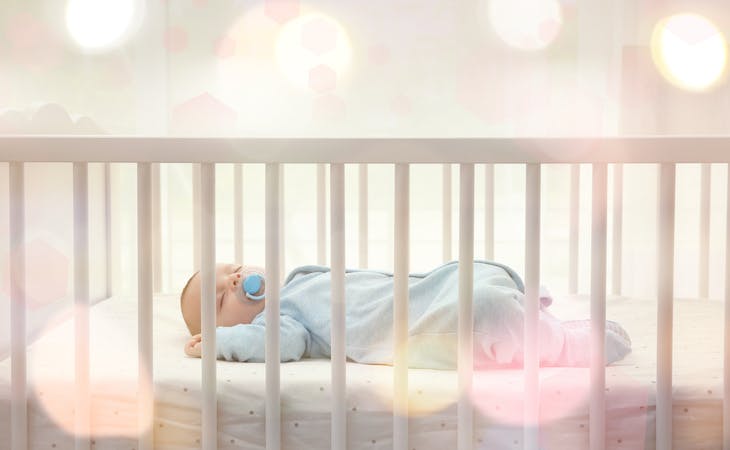 crib mattress dimensions - baby lying in crib