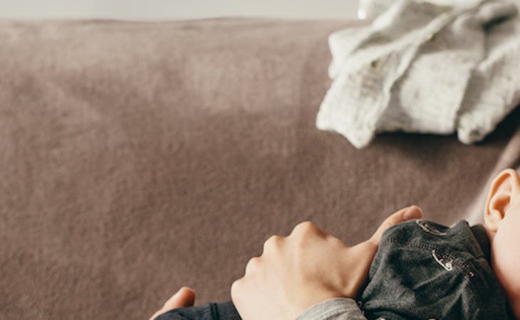 new mom and baby sleeping on couch