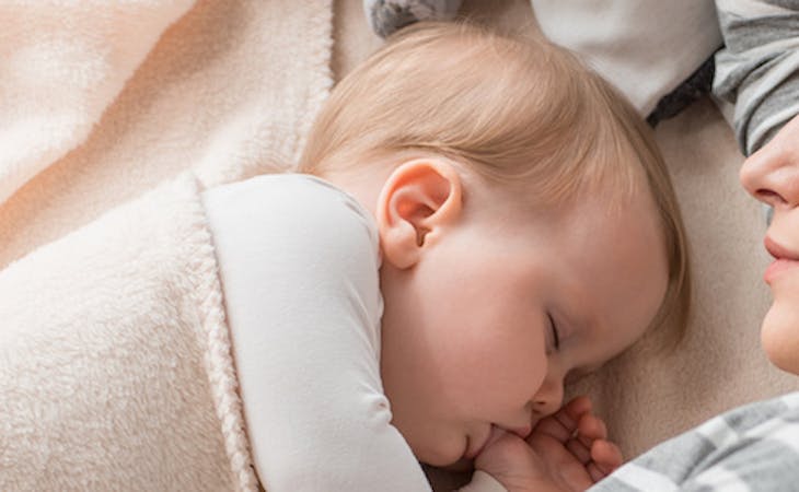 parent co-sleeping with baby in bed