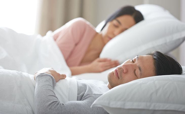 best mattress for adjustable base - image of couple lying on adjustable base