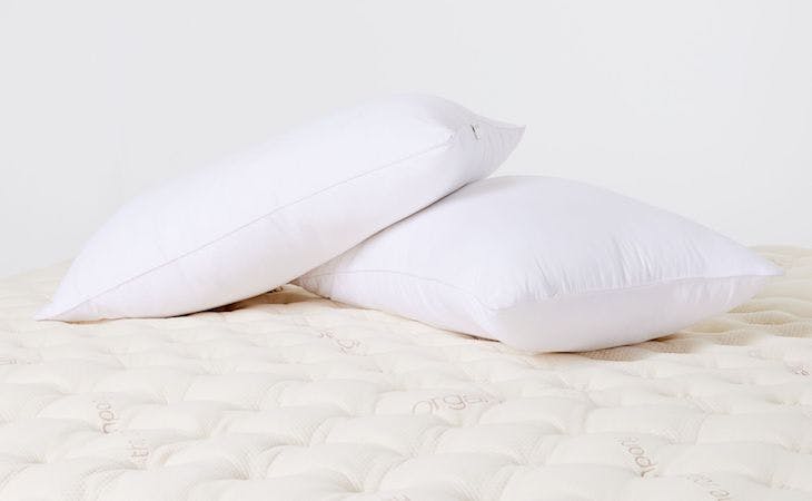 saatva down pillows on top of bed