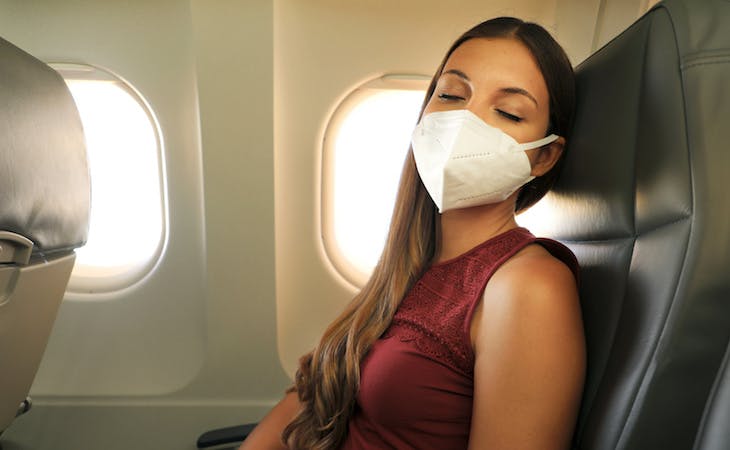 person sleeping on plane while traveling