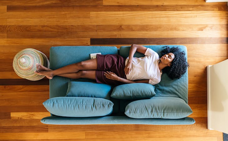 person napping on couch during afternoon