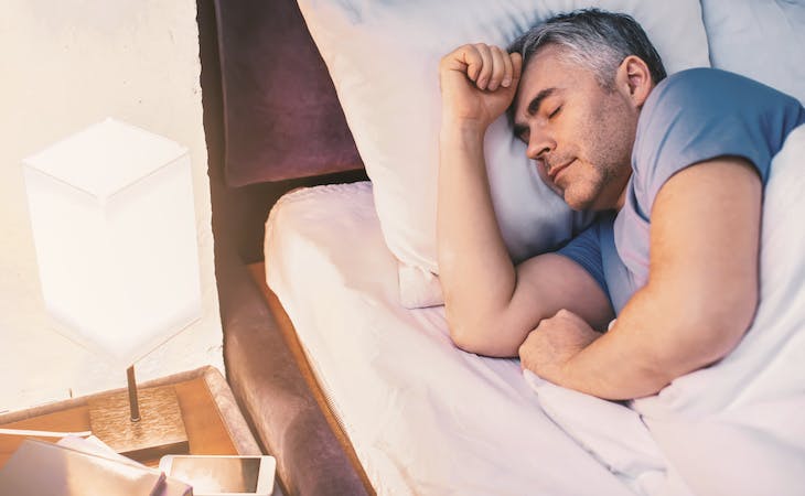 middle aged man sleeping in bed