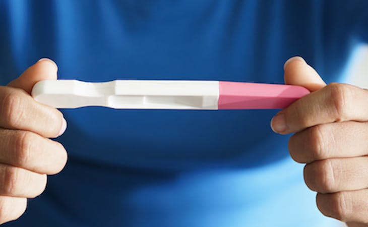 person holding a pregnancy test