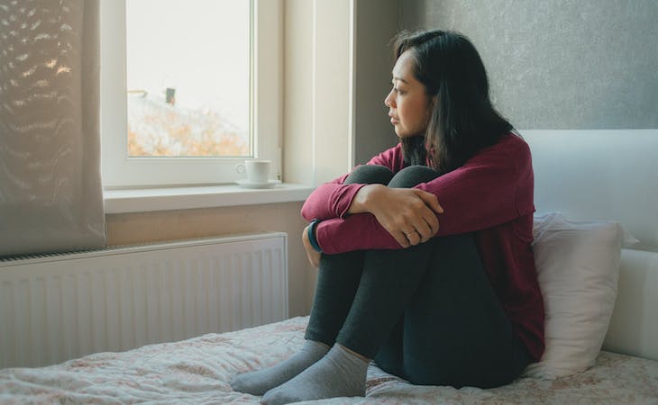 person with somniphobia staring out window