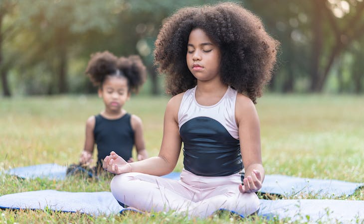 children meditating outside