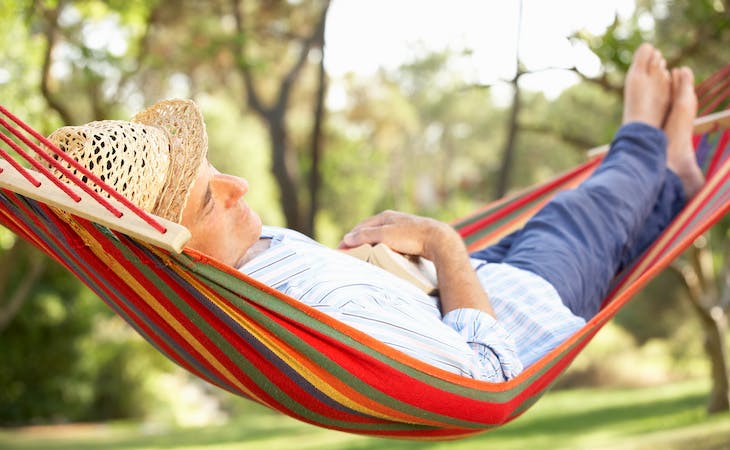 person sleeping outside in hammock