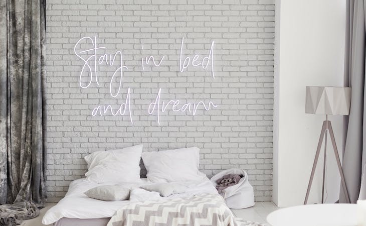aesthetic bedroom with neon sign above bed