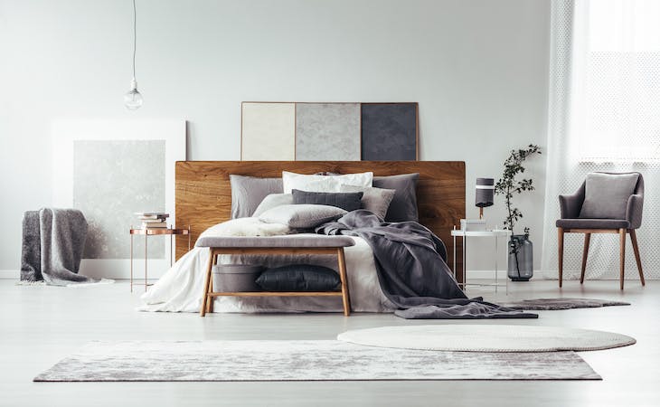 bedroom with layered rugs