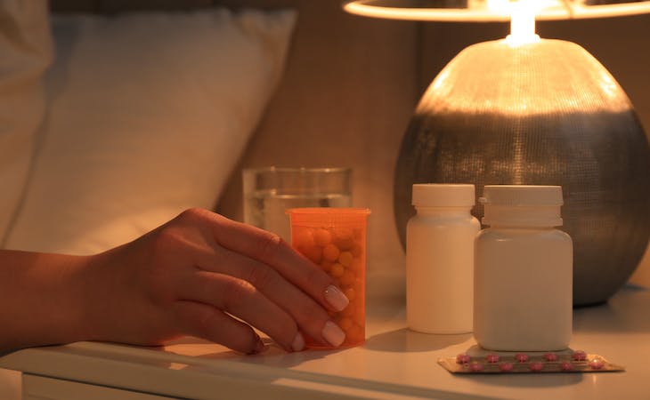 person holding an otc sleep aid bottle