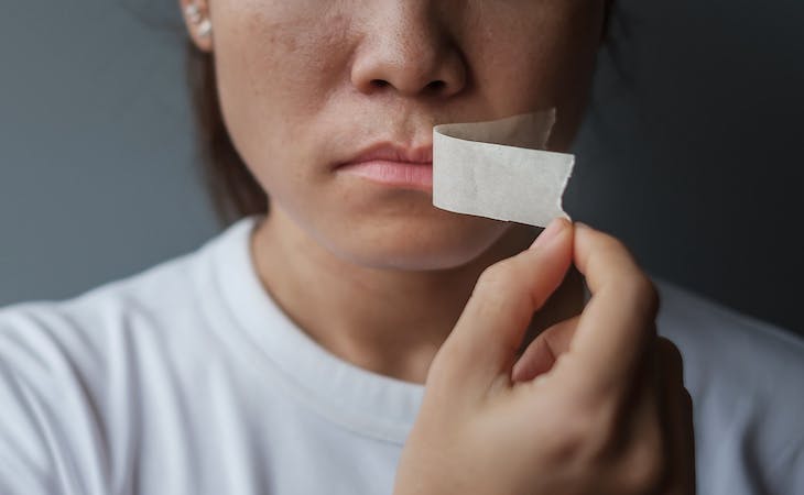 person with tape over mouth for sleep