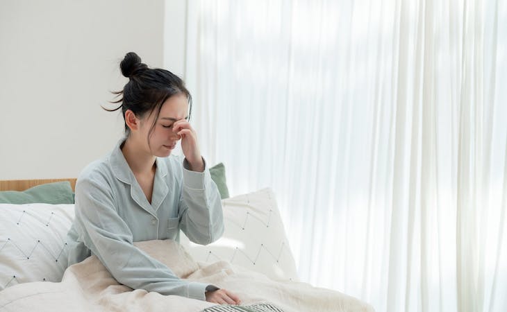 person with autoimmune disease sitting up in bed