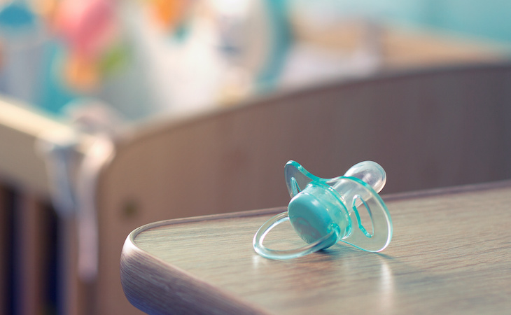 pacifier next to baby crib