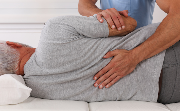 person being adjusted by chiropractor