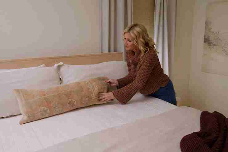 jenny marrs placing pillow on bed
