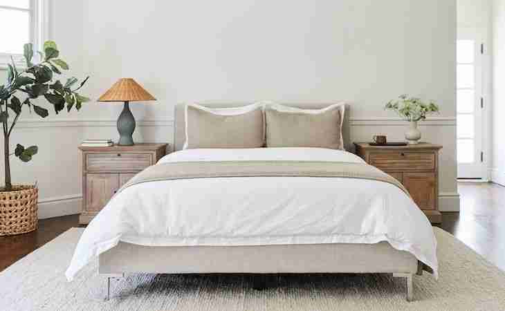 bed with multiple pillows on top of it